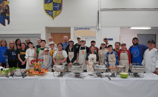 Volunteers and students collaborating and networking together at an Innovate for California dinner event, showcasing community engagement in education
