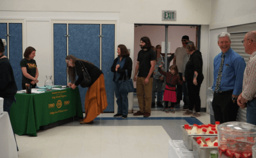 Group of diverse volunteers and students engaged in meaningful conversation at an Innovate for California community gathering, demonstrating inclusive educational support
